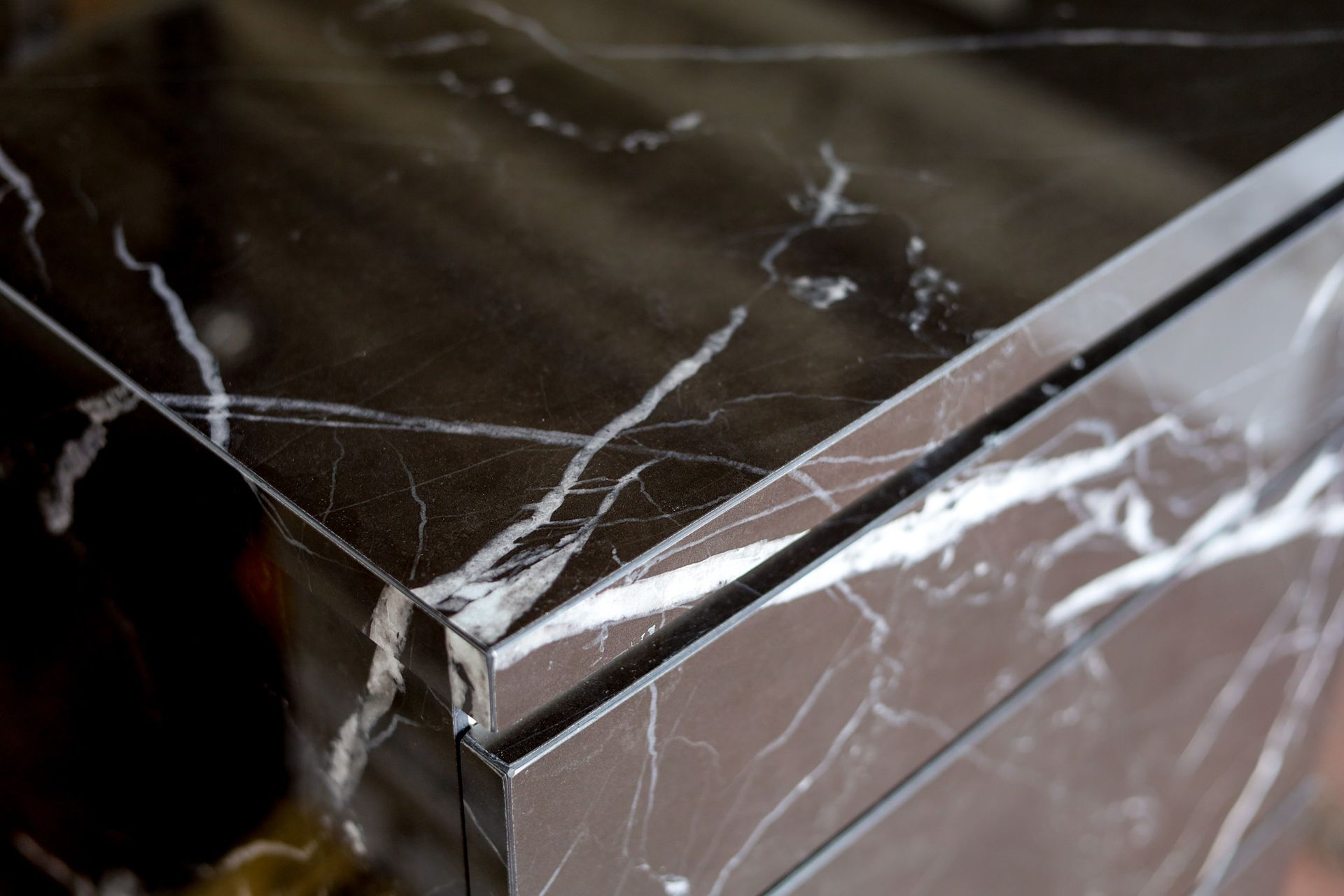 A close up of matching black and white porcelain cabinet and countertop.