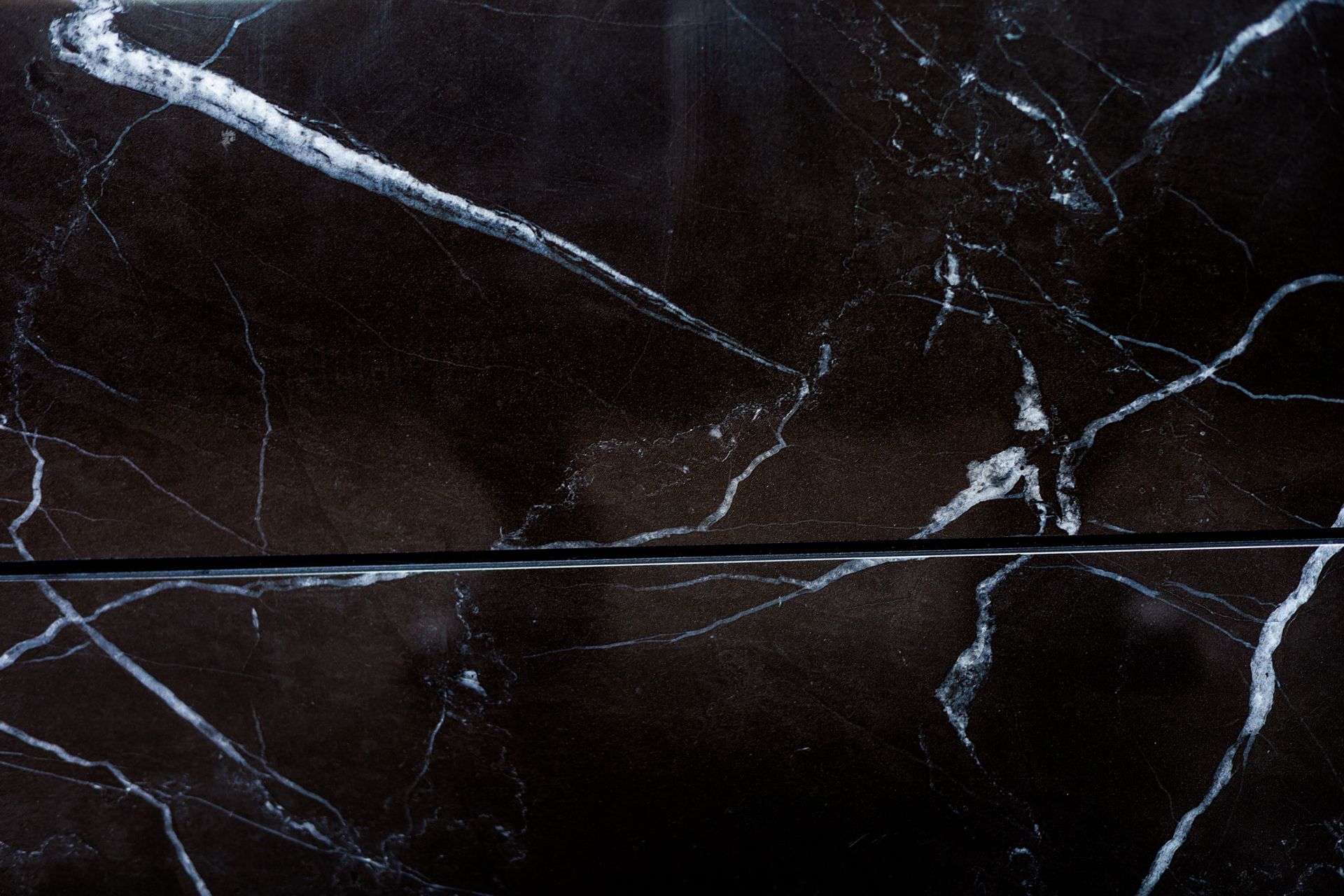A close up of a black and white porcelain marble surface