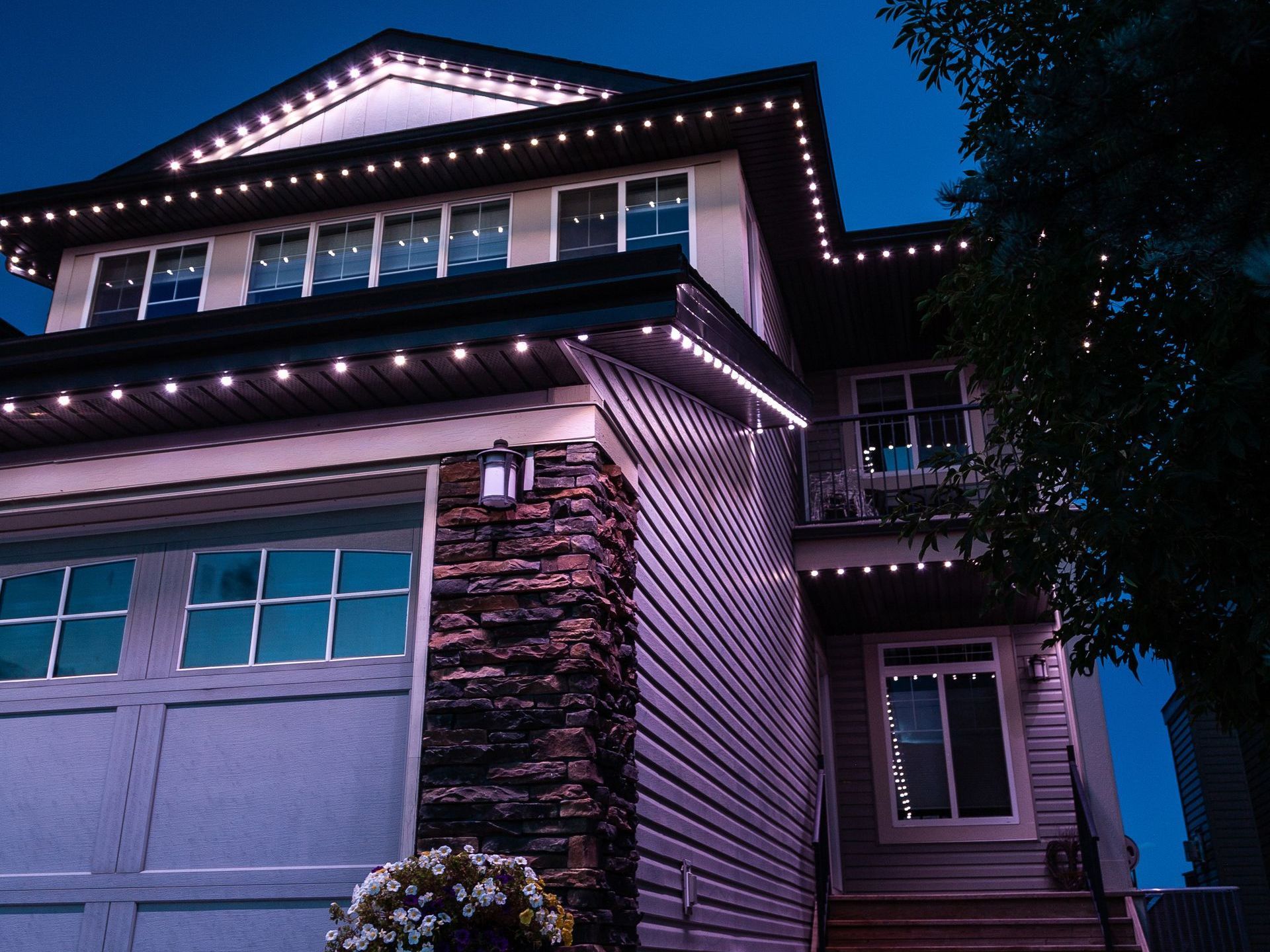 A house is lit up with christmas lights at night