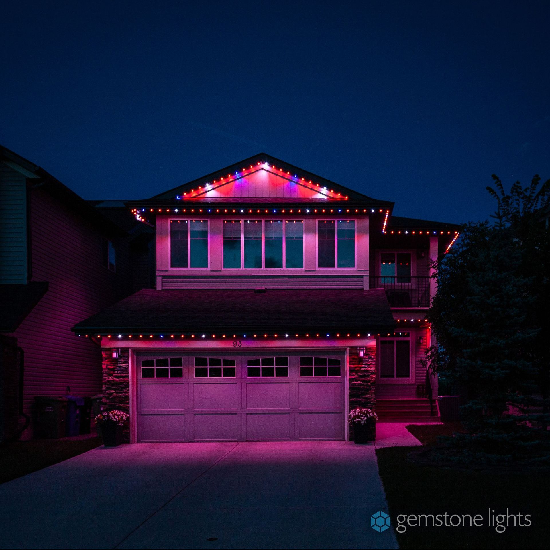 A house with purple lights on it at night
