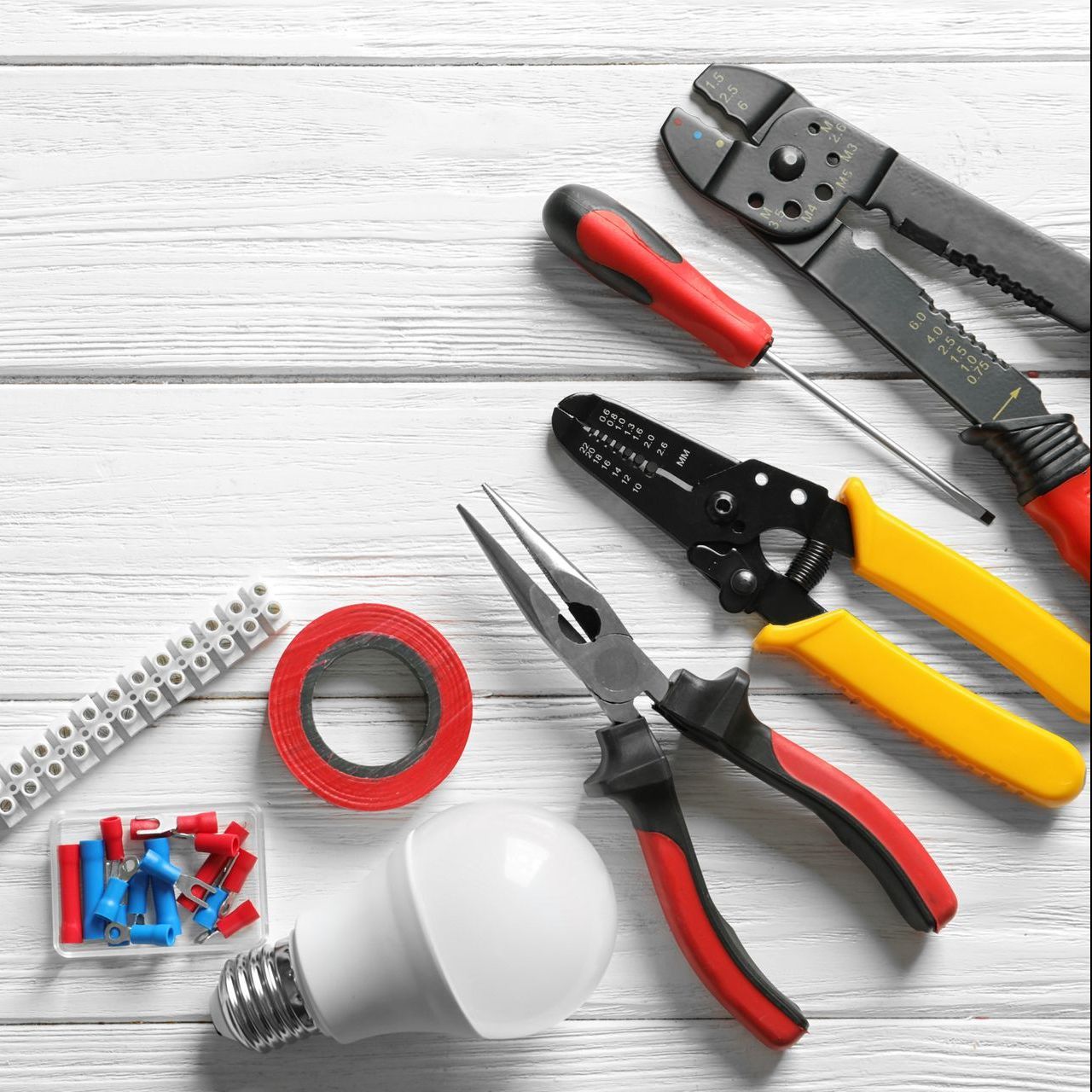 A bunch of electrical tools are on a wooden table