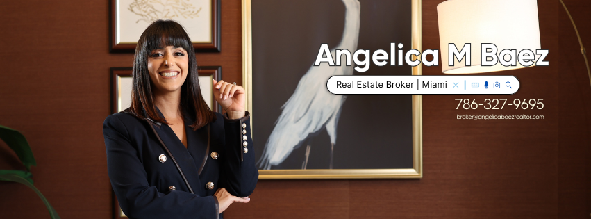 Professional portrait of Angelica M. Boez standing in an office, smiling beside a framed chalkboard sign.