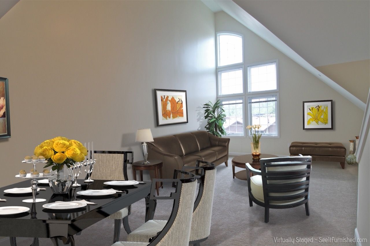 Furnished apartment living and dining area with a dark wood dining table, tan sofa, and large arched windows.