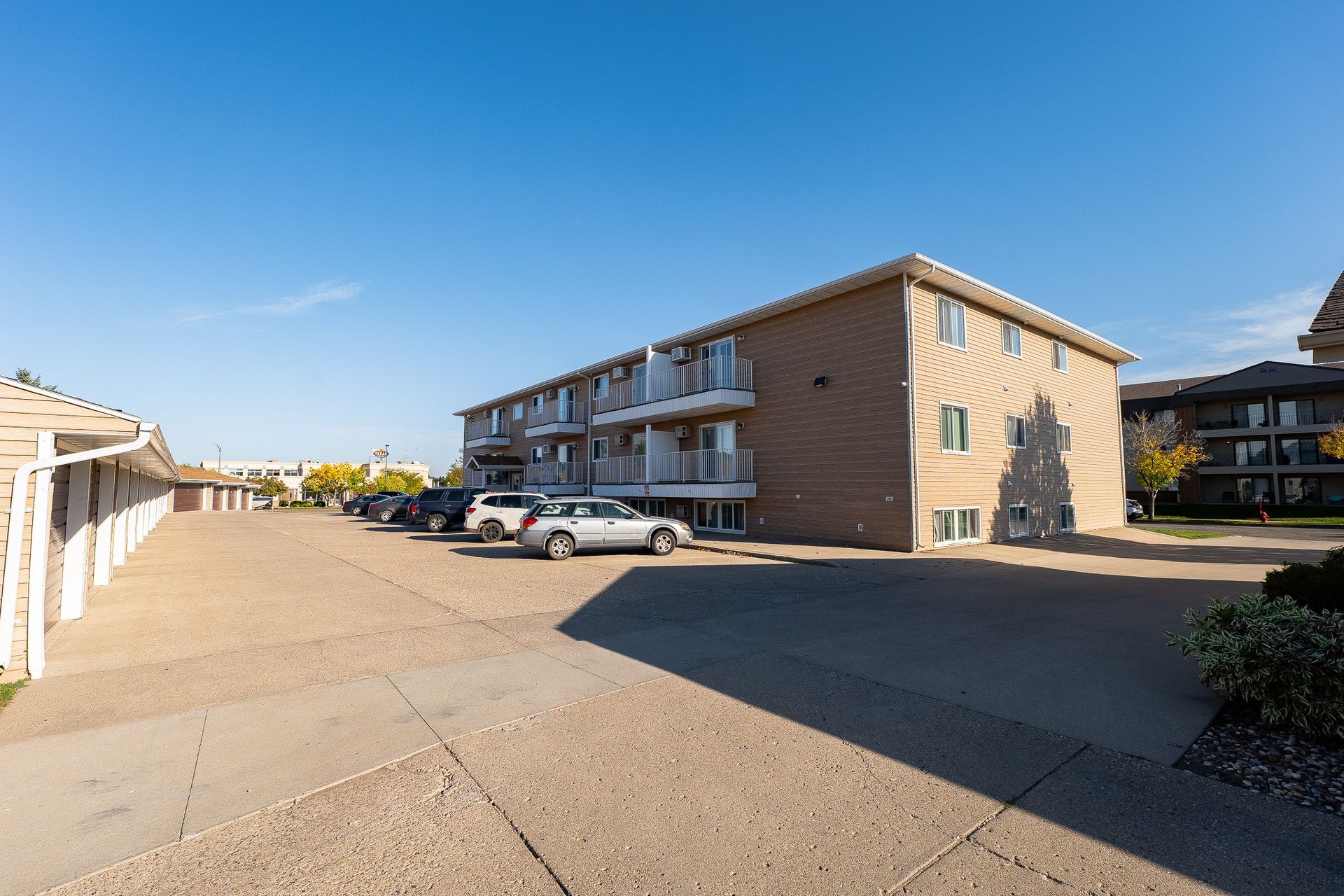 image of back of the grandview apartments with parking garages and exterior balconies