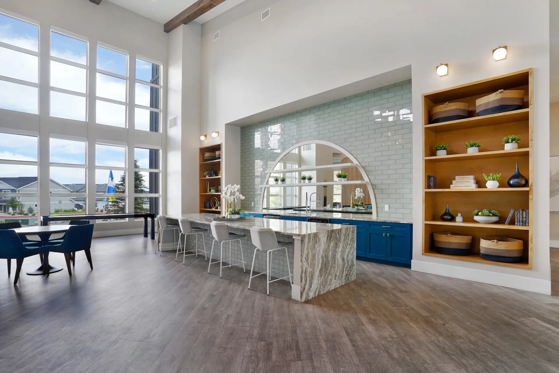 Spacious common area with a large island, bar seating, and large windows  at Valley View, offering apartments in Magna, UT.