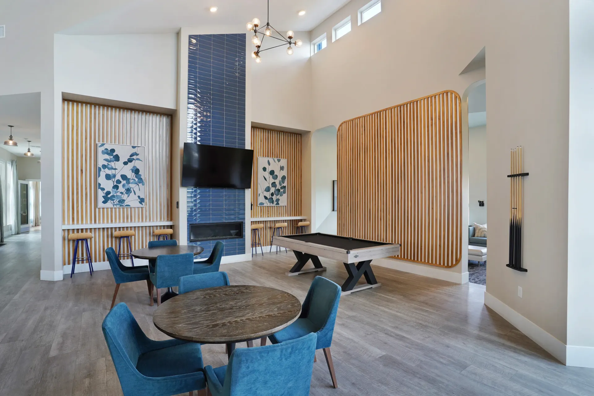 Clubhouse game room with pool table, seating areas, and fireplace at Valley View, offering apartments in Magna, UT.