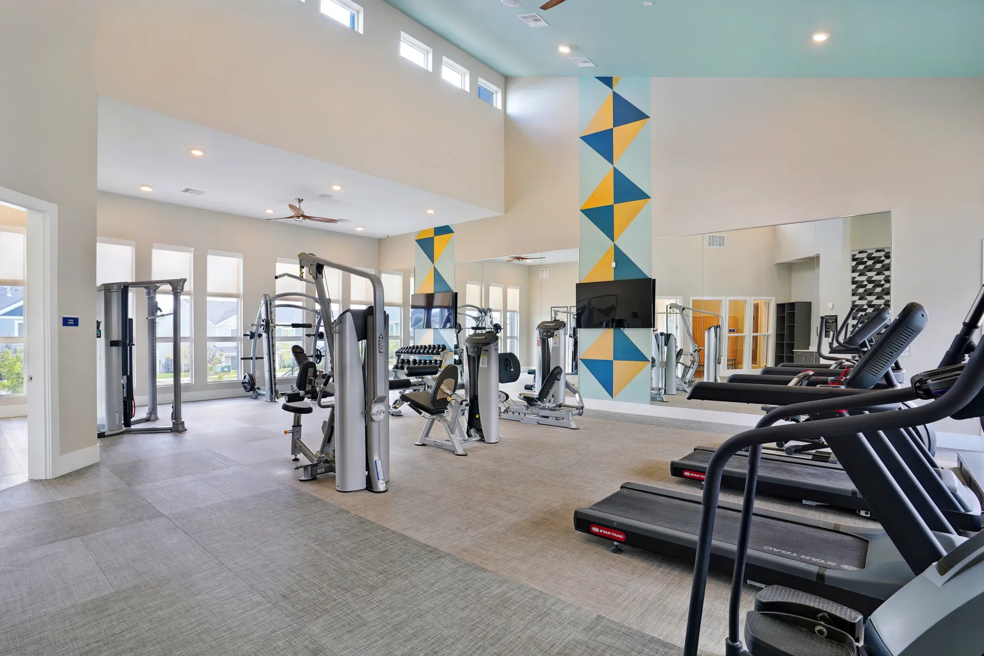 Gym with cardio machines, weight machines, and free weights at Valley View, offering apartments in Magna, UT.