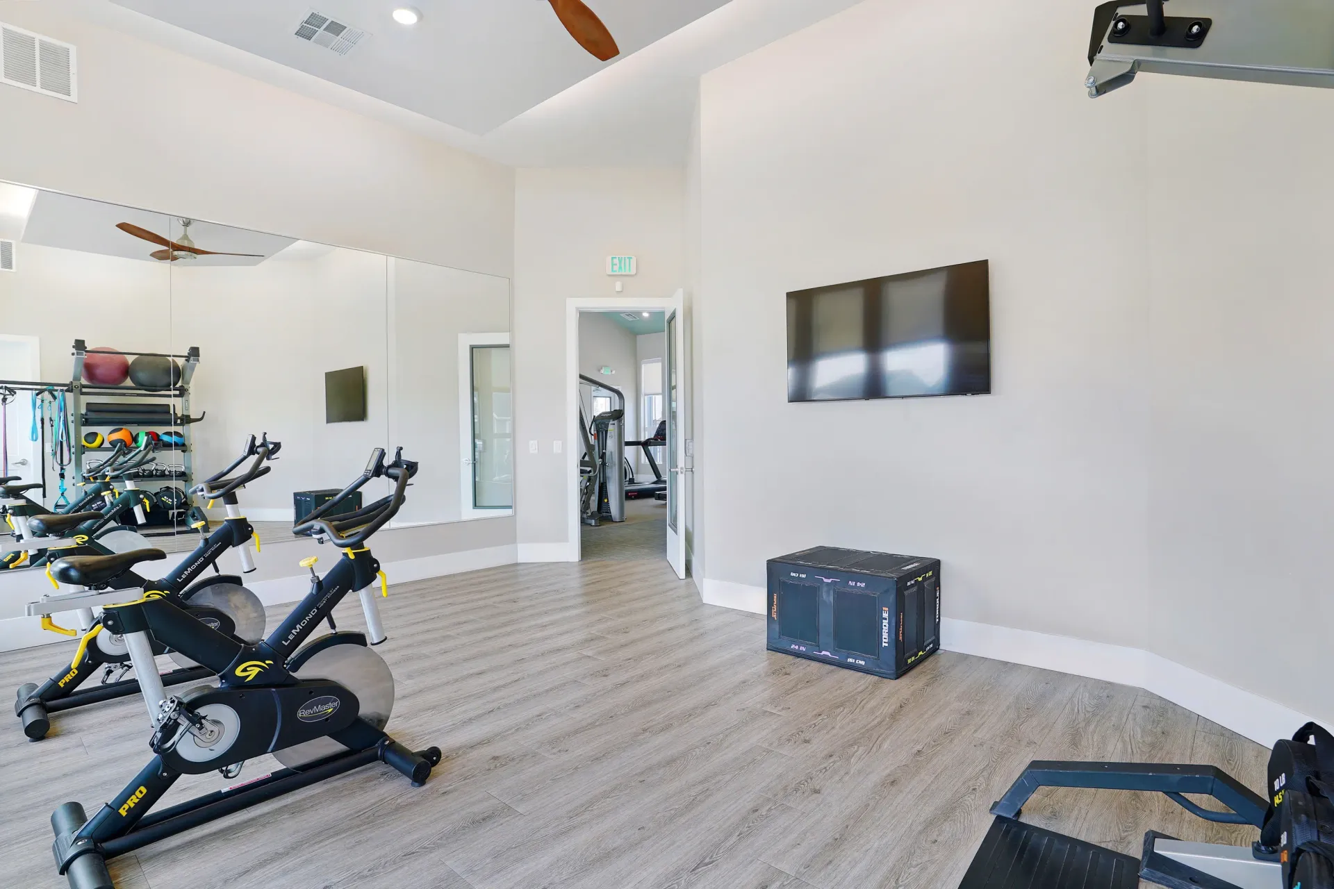 Well-equipped fitness center with stationary bikes, free weights, and cardio machines at Valley View, offering apartments in Magna, UT.