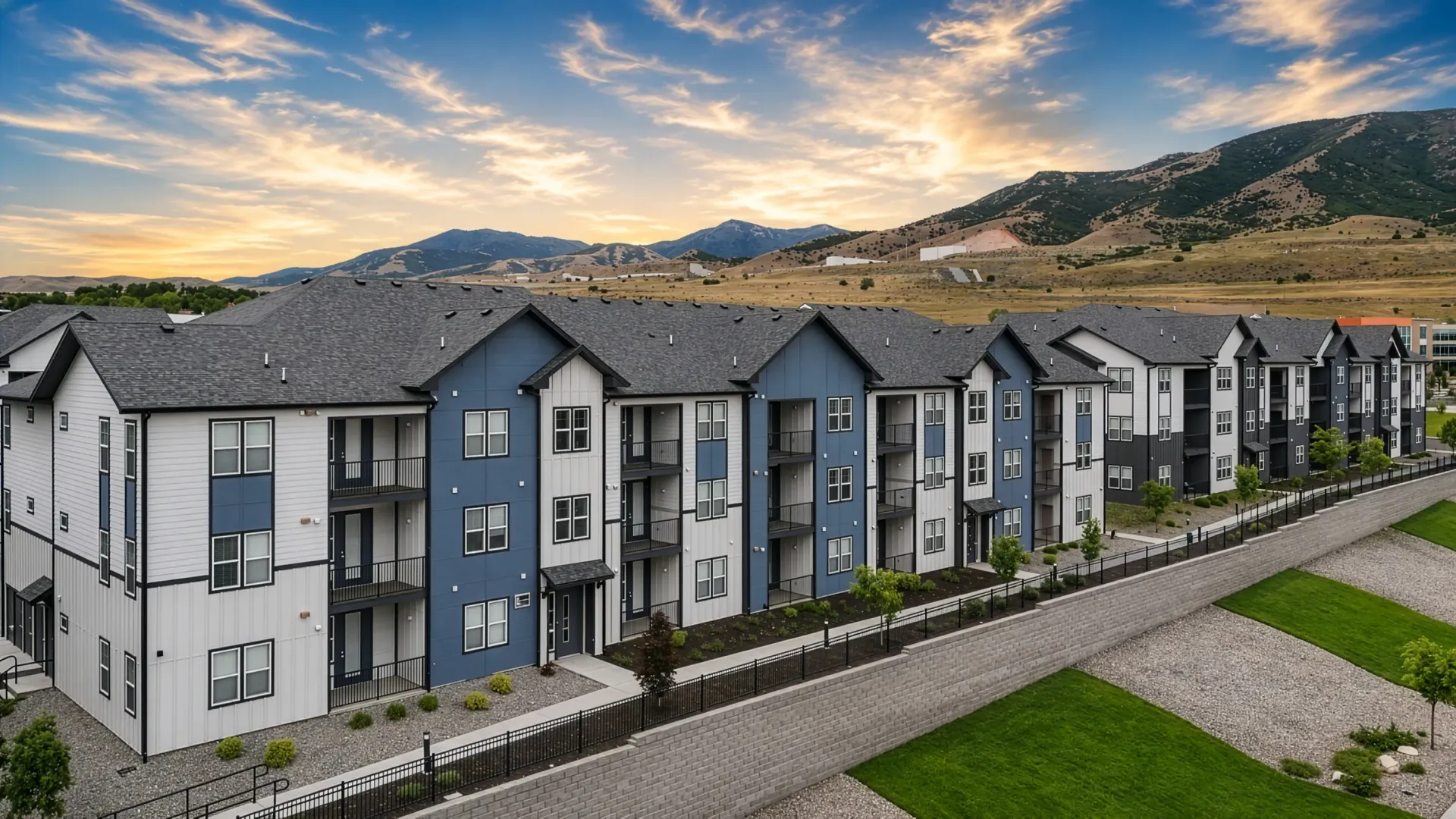 Exterior view of a modern, multi-story apartment building with balconies at Valley View, offering apartments in Magna, UT.