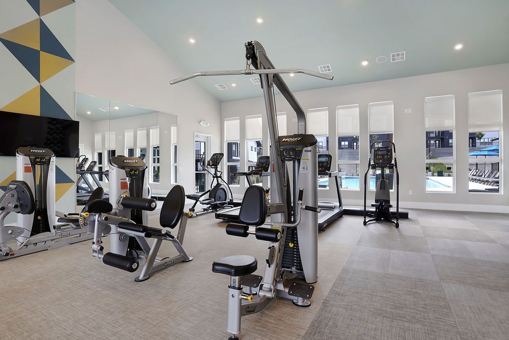 Bright modern fitness center with cardio machines and weight machines at Valley View, offering townhomes in Magna, UT.