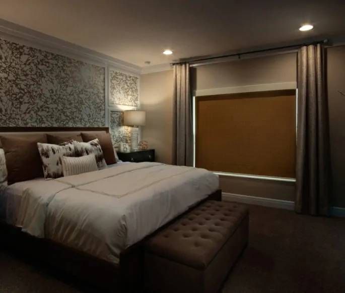 A Better Blind Roller Shades paired with drapery in a dark bedroom