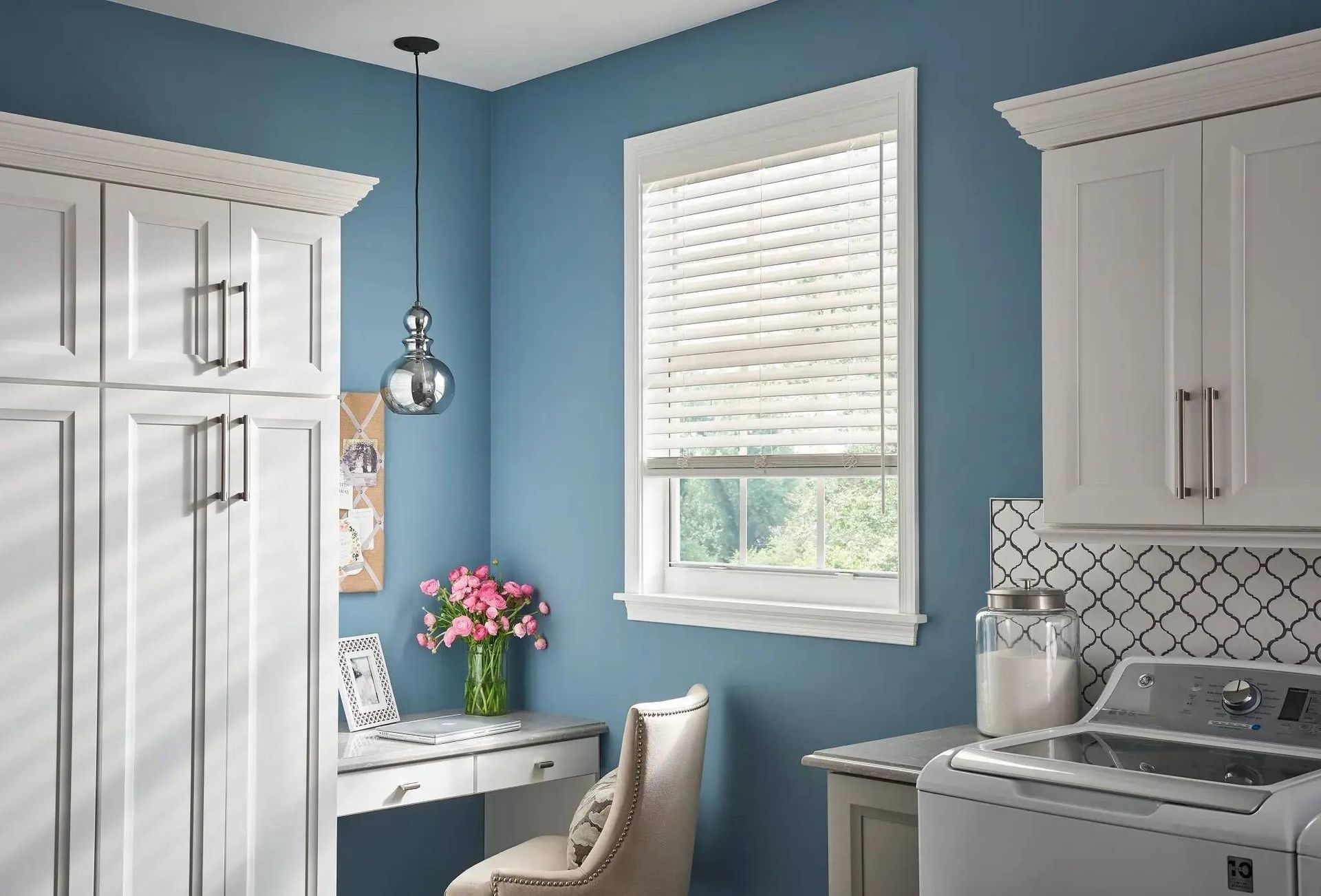 Alta Faux Wood Blinds on a small laundry room window with blue walls