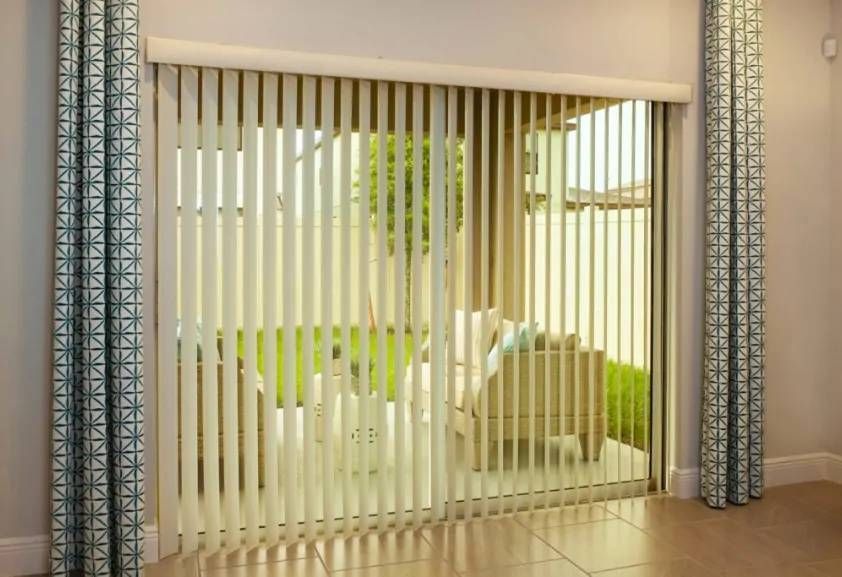 Better Blind Vertical Blinds on a large sliding door paired with patterned drapery