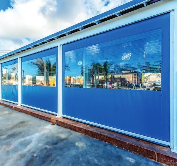Bright blue SunPro Commercial Screens on the outside of a local business to accommodate patrons