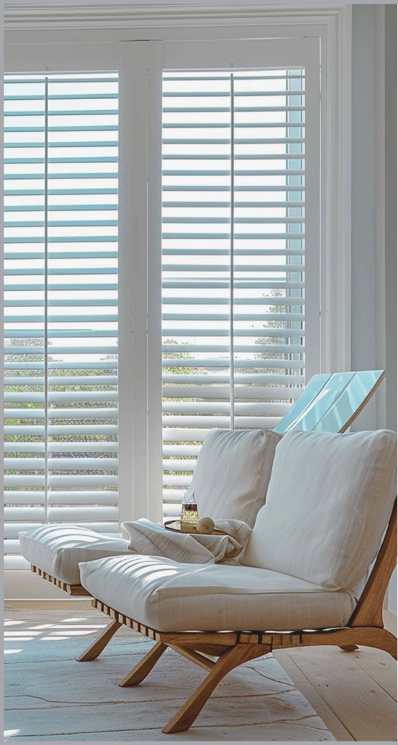 CACO Louvestar Shutters in a white color on windows in a living room