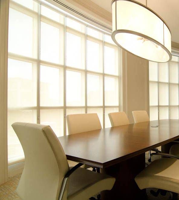 CACO Serenity Roller Shades on large windowpanes in a commercial office meeting space