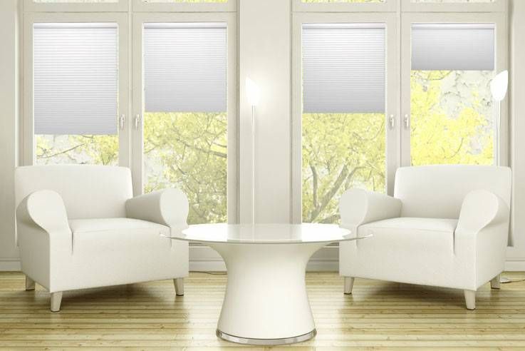 CACO Simply Cordless Cellular Shades in a while color on tall windows in a sitting room
