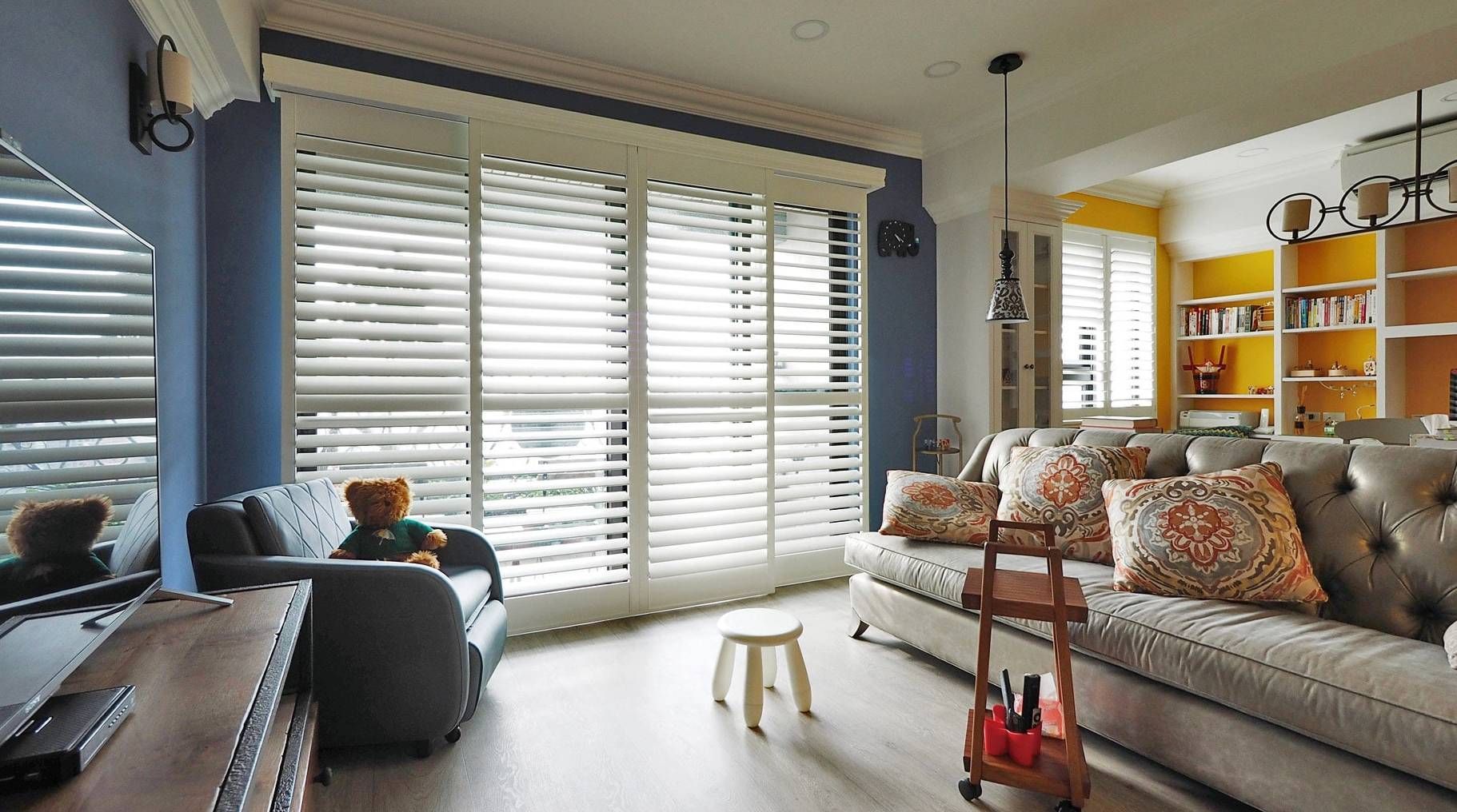 Norman® Normandy® Shutters on a large sliding door and a set of windows in living room