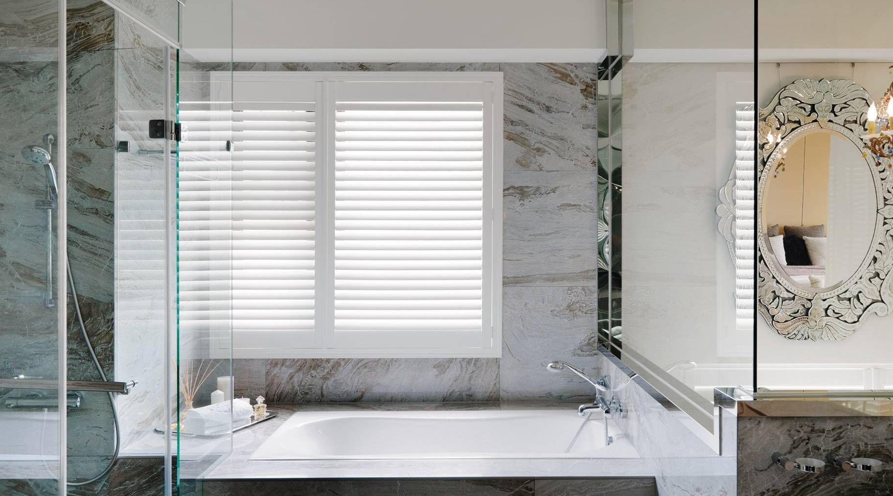 Norman® Woodlore® Plus Shutters in a white color on a bathroom window