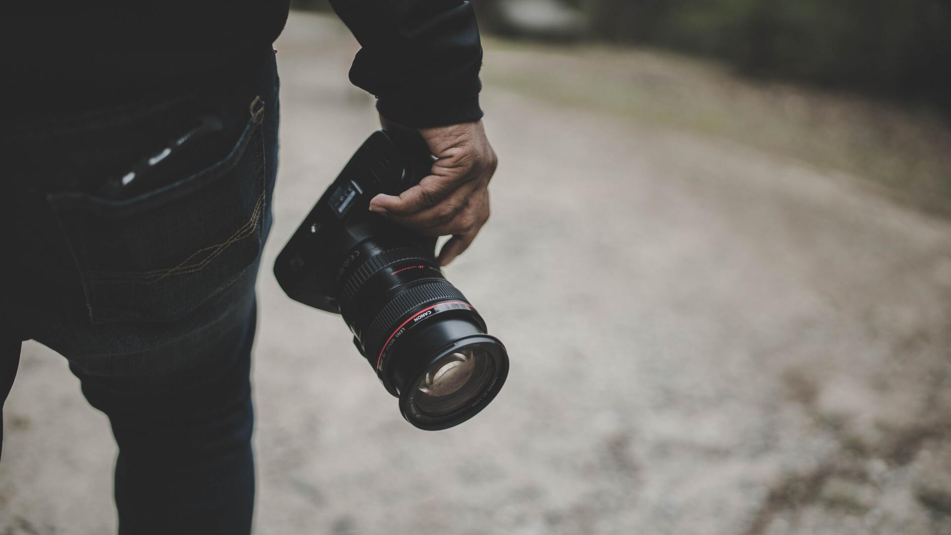man's hand holding a camera