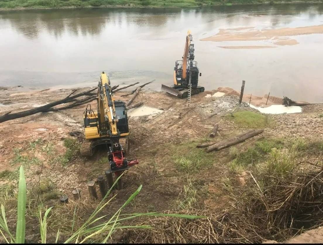 Construction Equipment Working Near a Riverbank — Macca's Dynamic Earthworks in Tolga, QLD