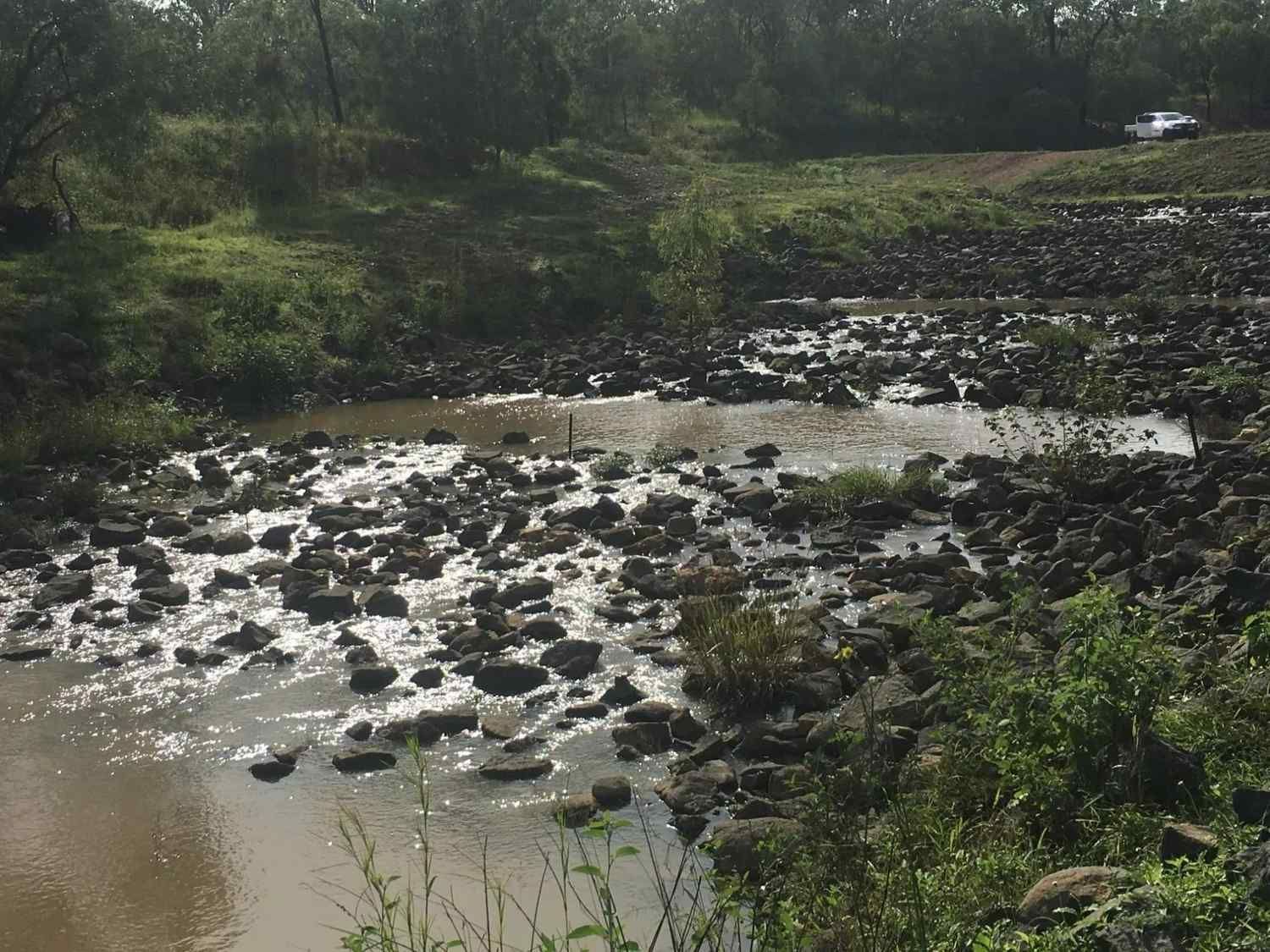 Riverbed with Rocks and Flowing Water — Macca's Dynamic Earthworks in Tolga, QLD