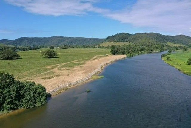 River Flows Past Grassy Banks and Hills — Macca's Dynamic Earthworks in Tolga, QLD