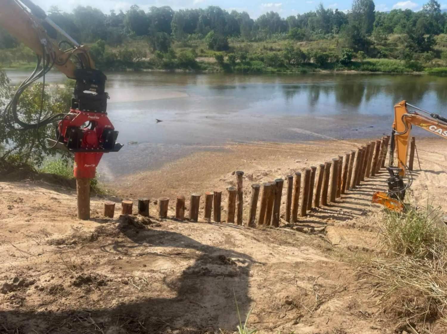 Construction of A Riverbank Barrier with Wooden Posts — Macca's Dynamic Earthworks in Tolga, QLD