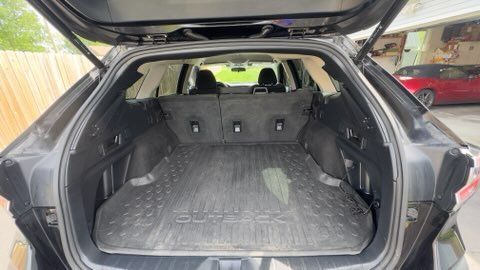 Open SUV cargo area with the rear seats folded down, showing a large empty trunk space.