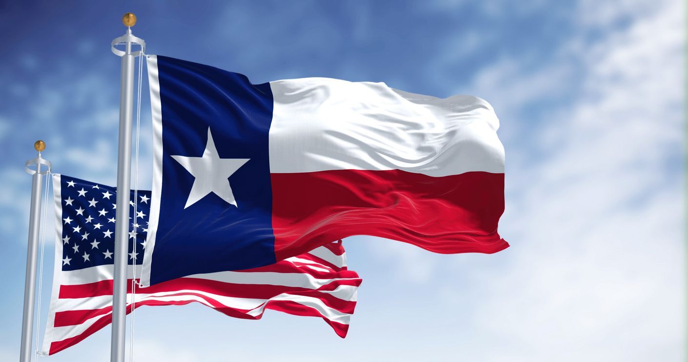 Texas Flag and American Flag Blowing in the Wind in Houston TX