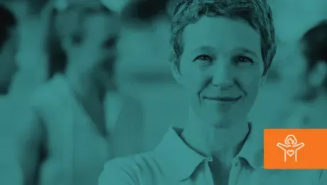 Smiling woman in teal-tinted photo with blurred figures in the background.