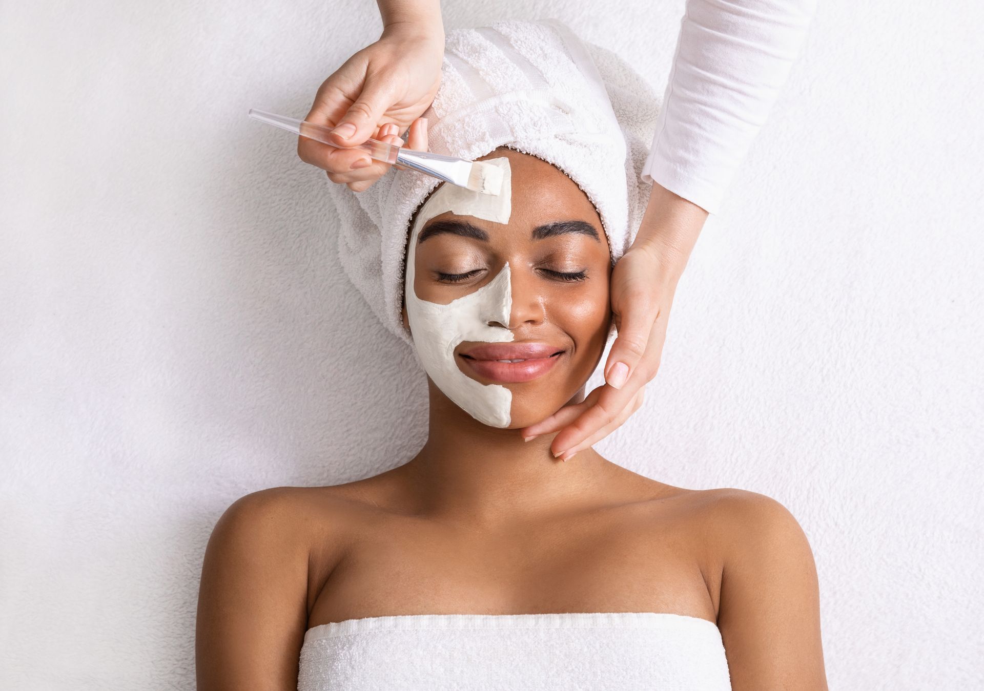 A woman is getting a facial treatment at a spa.