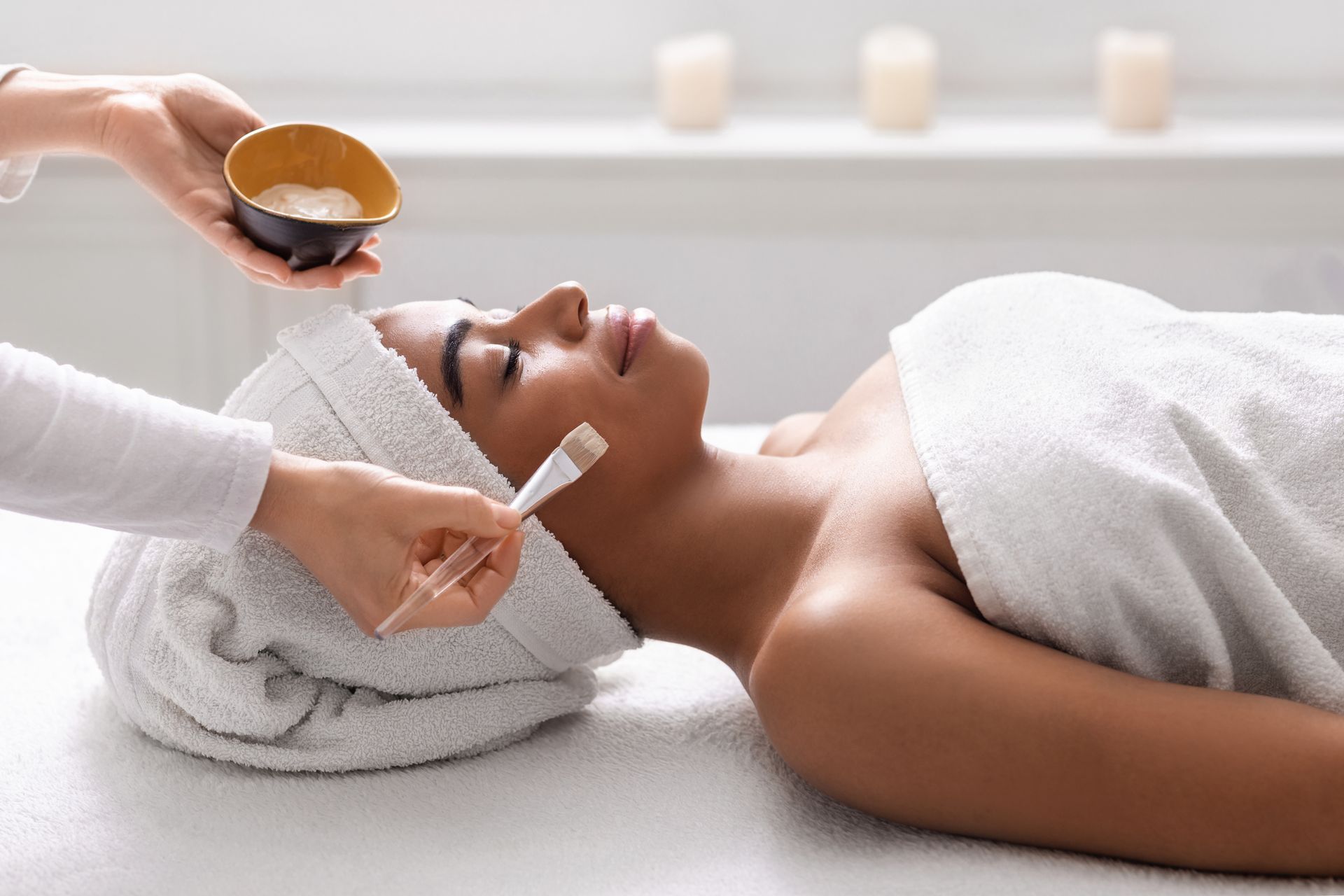 A woman is getting a facial treatment at a spa.