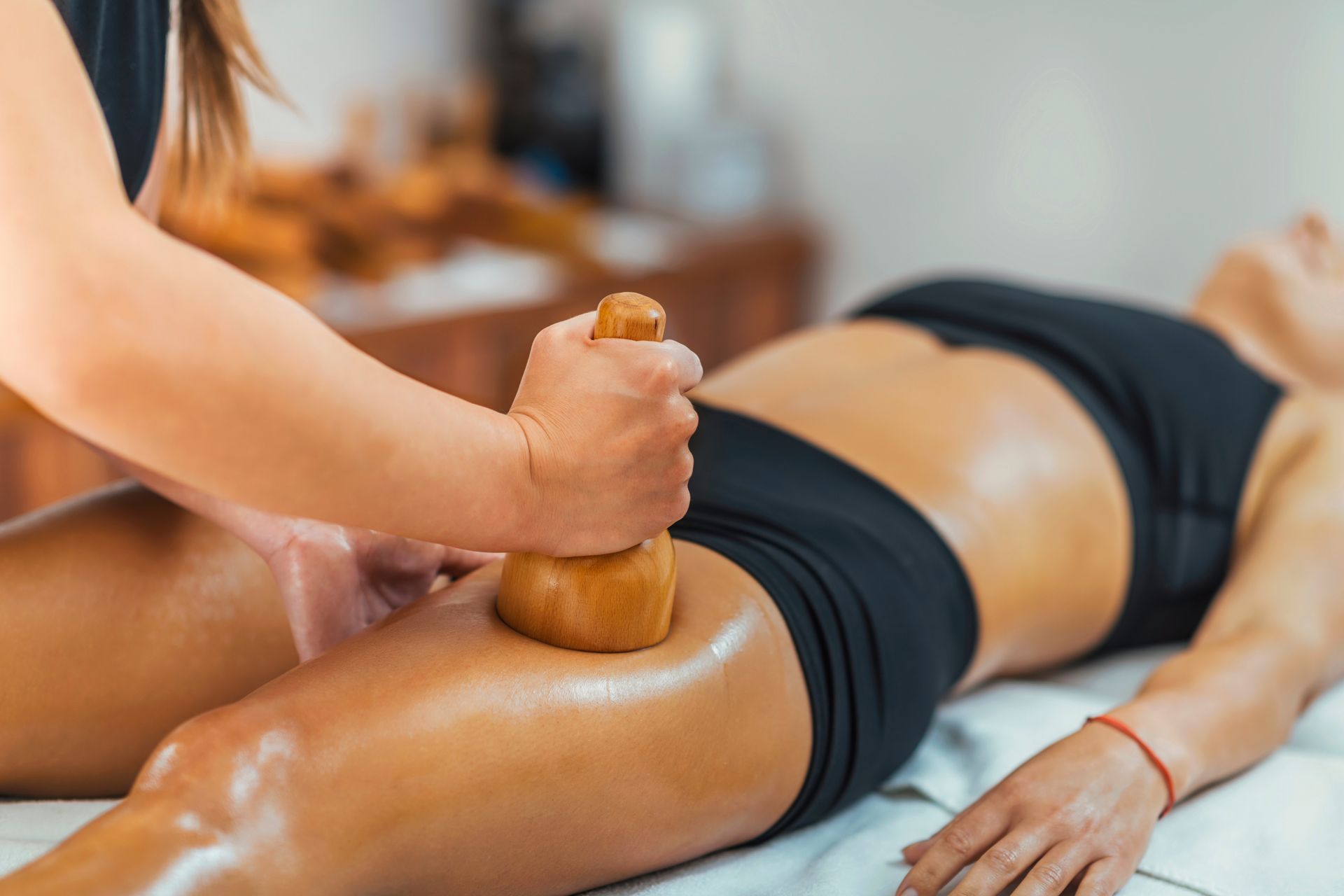 woman getting a wooden cup massage