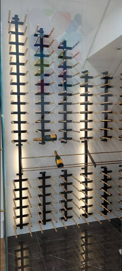 Wall-mounted retail display of eyeglasses and sunglasses on white shelves in a store