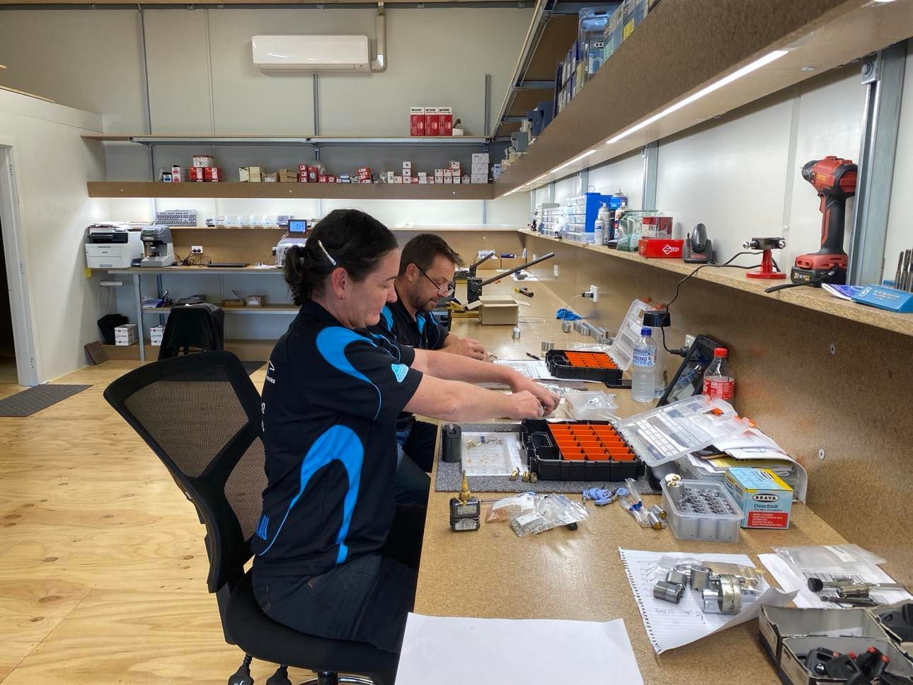 Man And Women Cutting Commercial Keys — KeyBay in Mittagong, NSW