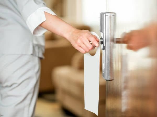 Person is Holding a Door Handle With a Sign on It — KeyBay in Bundanoon, NSW
