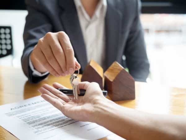Man is Giving a Woman a Set of Keys While Sitting at a Table — KeyBay in Narellan, NSW