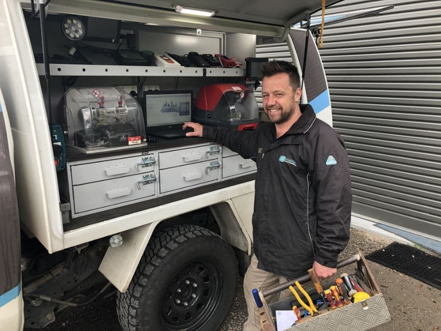 Man is Standing in Front of a Truck Holding a Toolbox — KeyBay in Harrington Park, NSW