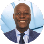 A man in a suit and tie is smiling in a circle.