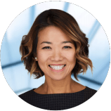A woman with short hair is smiling in a circle.