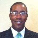 A man in a suit and tie is smiling for the camera.