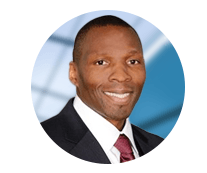 A man in a suit and tie is smiling in a circle.