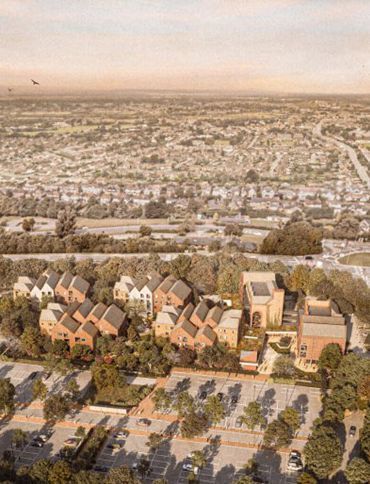Aerial view of a suburban neighborhood with tan rooftops, parking lot, and sprawling homes under a hazy sky