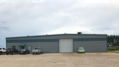 A large building with cars parked in front of it.