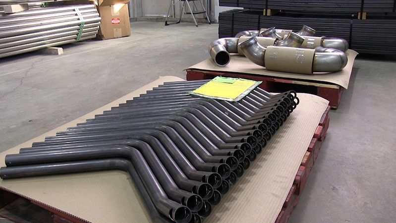 A bunch of metal pipes are stacked on top of each other