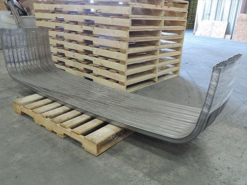 A metal object is sitting on top of a wooden pallet.