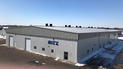 An aerial view of a large metal building with the word ritz on it.