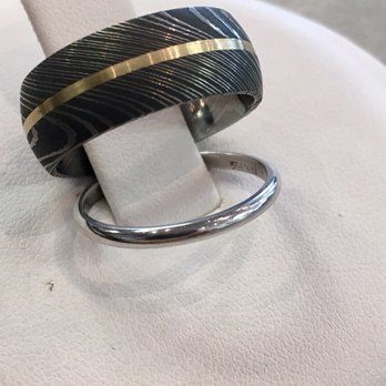 A couple of rings are sitting on a white surface.