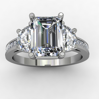 A white gold ring with an emerald cut diamond in the center